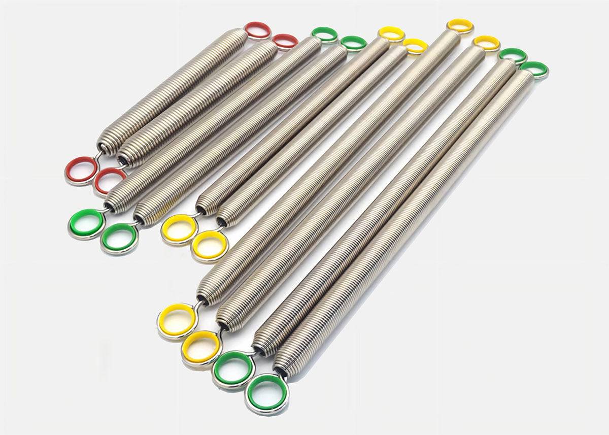 Set of Pilates Trapeze Springs for Cadillac, Springboard, and Tower with color-coded hooks for resistance levels. High carbon steel, nickel-plated finish.