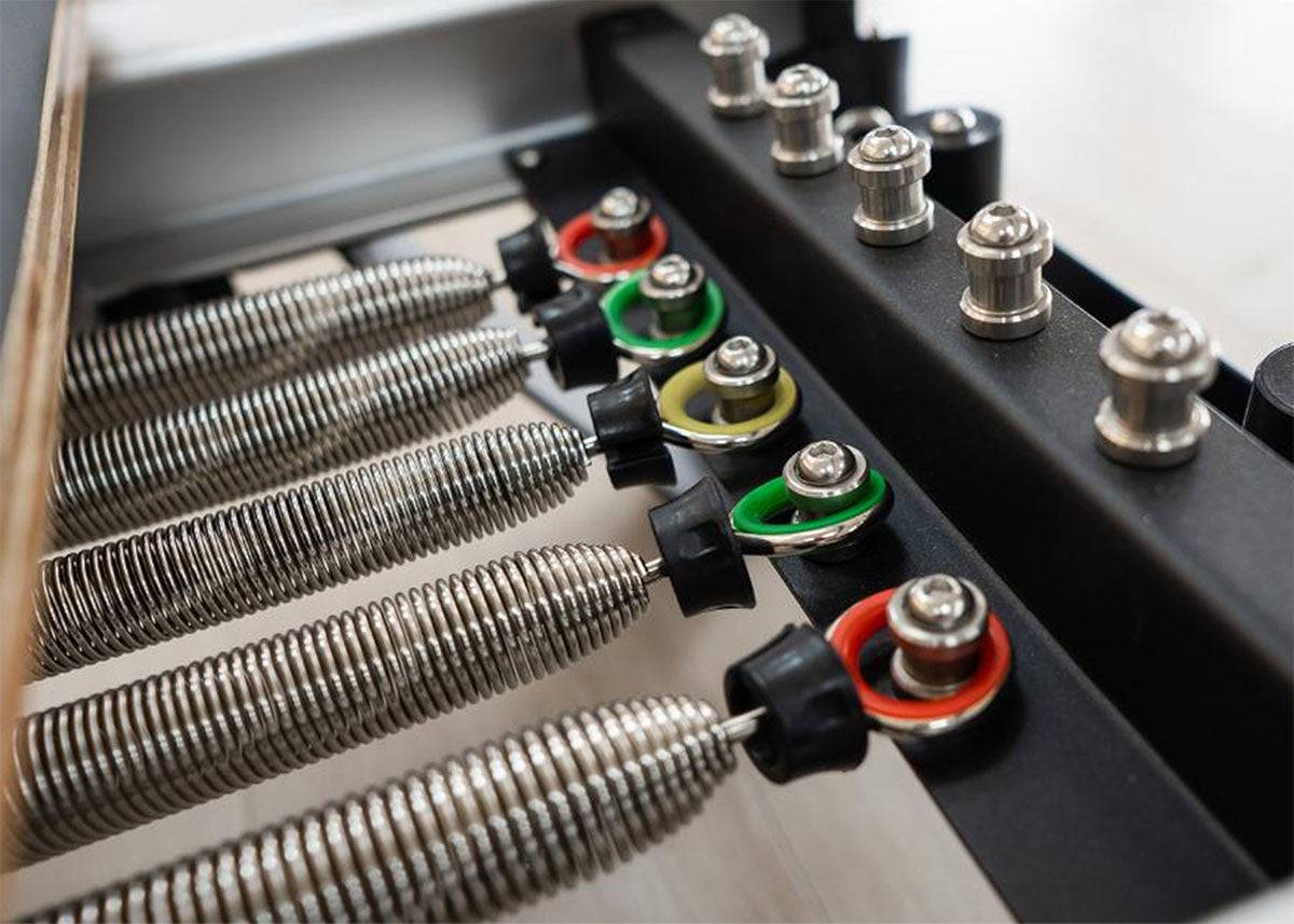 Pilates Reformer Springs for Replacement with color-coded tension levels, made of high carbon steel and nickel-plated for 4-year rust-proof durability.